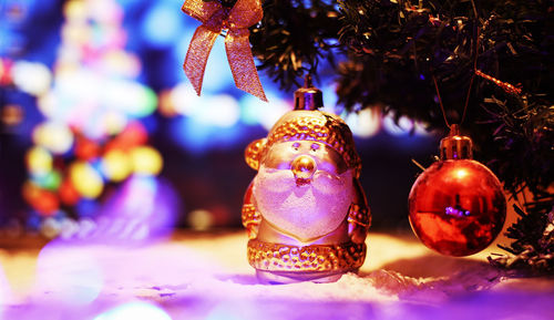 Close-up of christmas decorations hanging on tree