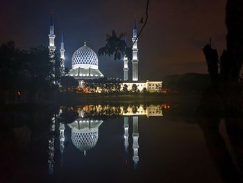 Reflection of illuminated building in water at night