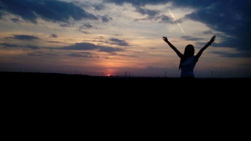 Silhouette of people at sunset