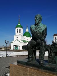 Statue against blue sky