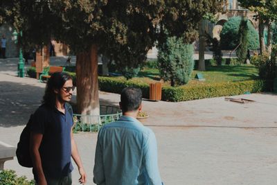 Men walking on footpath at park