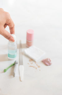 Cropped hand of woman holding manicure equipment