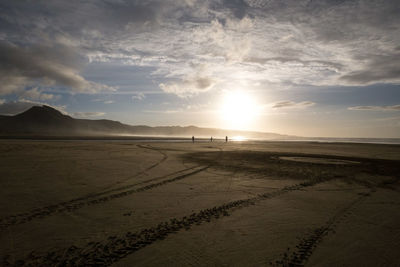 Scenic view of beach against sky during sunset