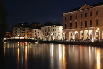 Reflection of buildings in city at night