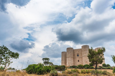 Old ruin on field against sky