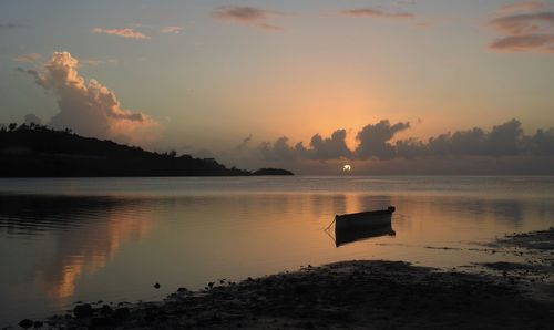 Scenic view of lake against sky at sunset
