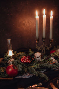 Christmas academia vintage romantic table with fir, candles, mulled wine, red decorations