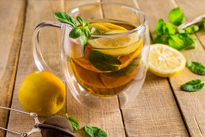 Tea with lemon and mint in a transparent cup. alternative medicine. hot drink for relaxation.
