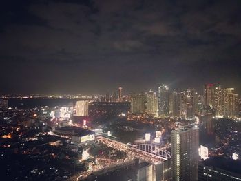 High angle view of illuminated city buildings at night