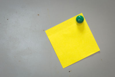 High angle view of yellow paper on table