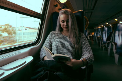 Young woman sitting in train