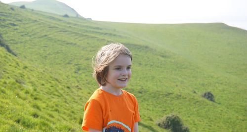 Portrait of smiling boy standing on field