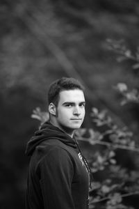 Portrait of man standing against plants at park