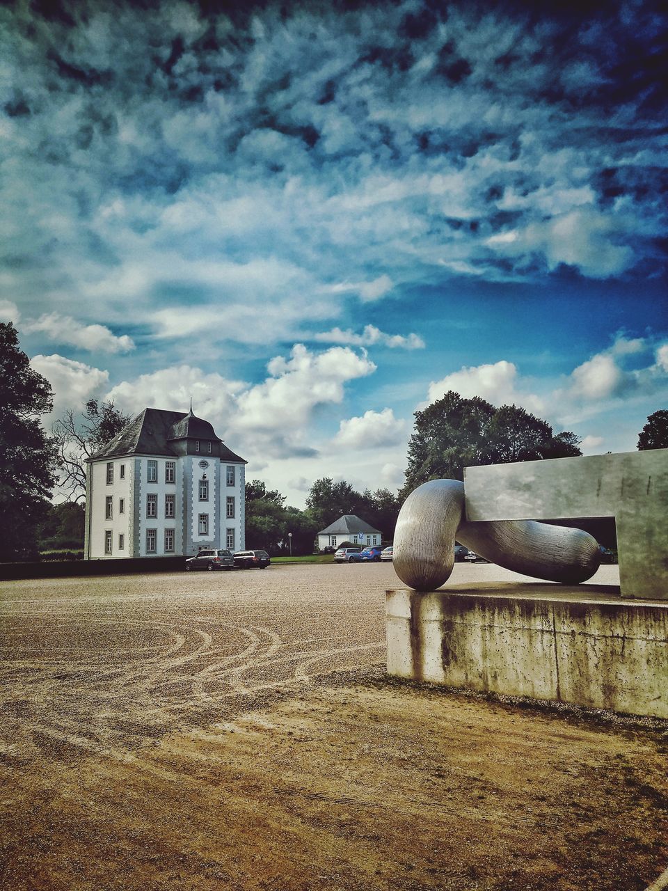 HOUSES ON FIELD AGAINST SKY