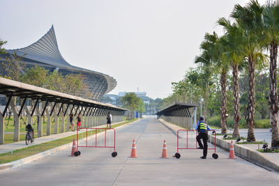 Barricades on street by stadium against sky