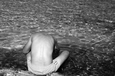 Man with horse in swimming pool