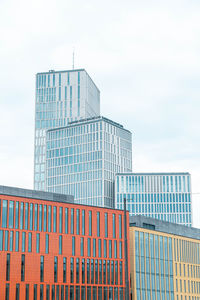 Low angle view of modern buildings against sky