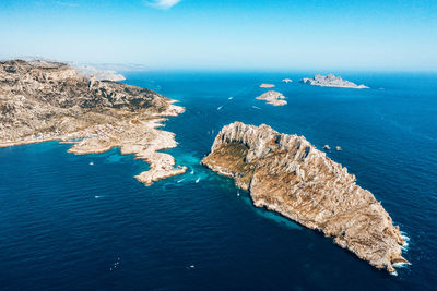 High angle view of rock formation in sea against sky