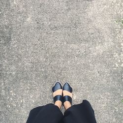 Low section of woman standing on ground