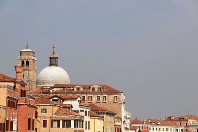 Buildings in city against sky