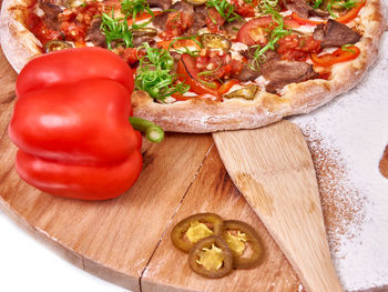 High angle view of pizza on cutting board