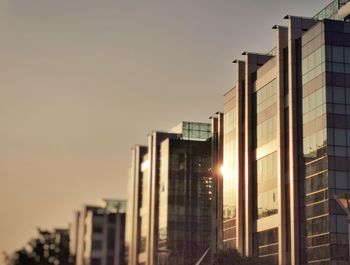 Low angle view of buildings against sky during sunset