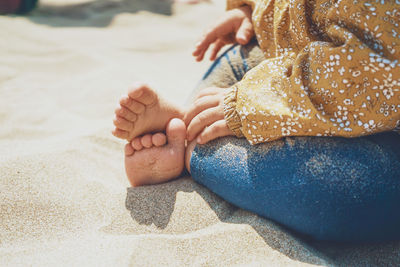 Close-up of baby hand on sand