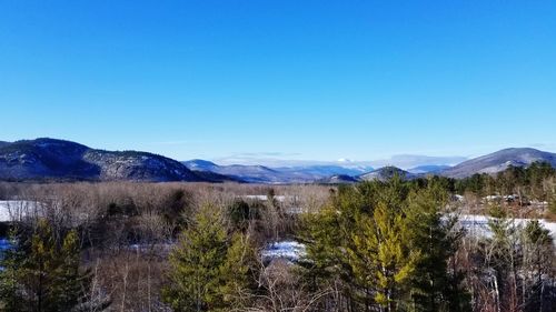 Scenic view of mountains against clear blue sky