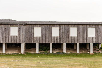 Barn on field against clear sky