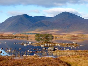 Scenic view of lake and mountains against sky