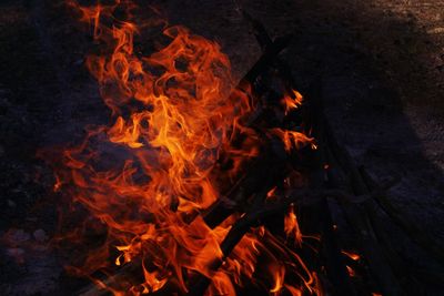Close-up of bonfire on field at night