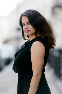 Portrait of beautiful young woman standing outdoors