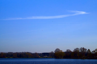 Scenic view of lake against blue sky