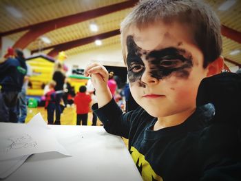 Portrait of boy holding paper