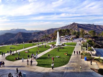 People at griffith park observatory against sky