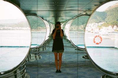 Rear view of woman standing in bus