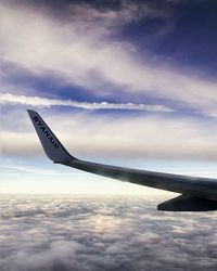 Airplane flying over cloudscape against sky