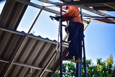 Low angle view of man working at construction site