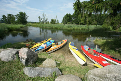 Boats moored on lake against sky