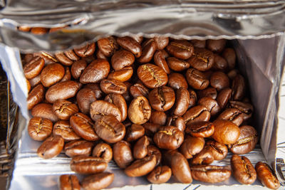 Coffee beans are in an open package. close-up. background image