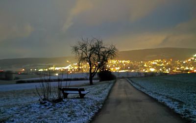 Illuminated city against sky during winter