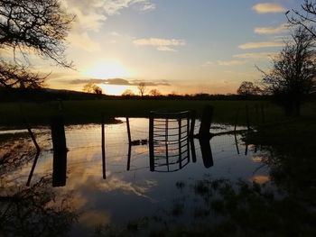 Scenic view of lake against sky during sunset