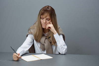 Young businesswoman working at desk in office