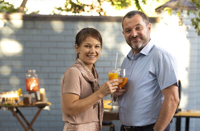 Portrait of young woman drinking beer in cafe