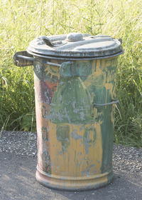 Close-up of garbage can on grass