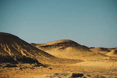 Scenic view of arid landscape against clear sky