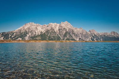 Asitz mountain in the background of the pure and calm lake, austria