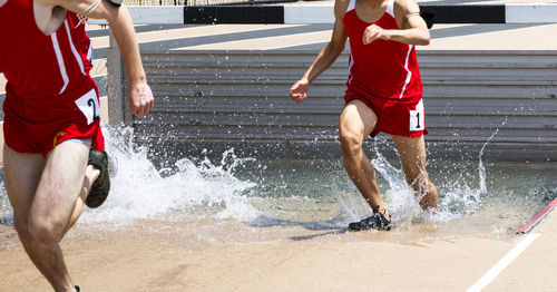 Rear view of man running on water