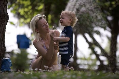 Side view of mother and daughter in park