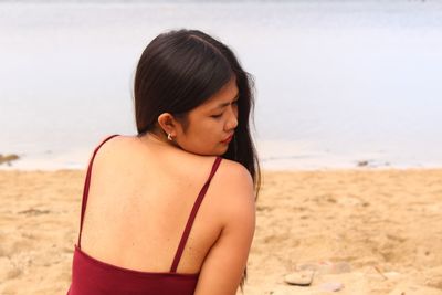 Beautiful woman standing at beach